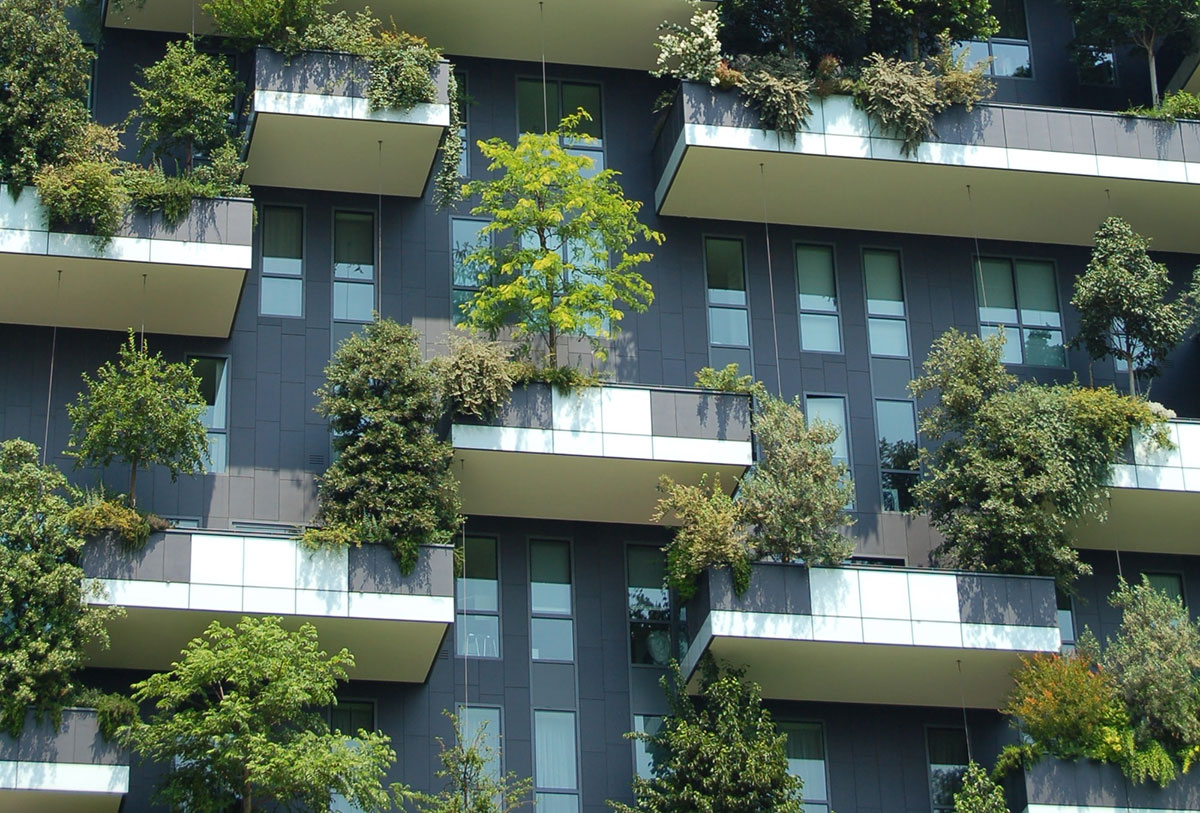 Photo of buildings with lots of greenery on balconies